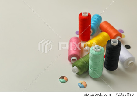 Sewing threads and buttons on white background, space for text 72333889