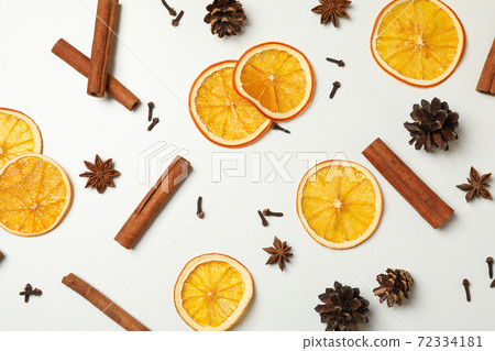Cinnamon, orange slices and cones on white background Cinnamon, orange slices and cones on white background 72334181