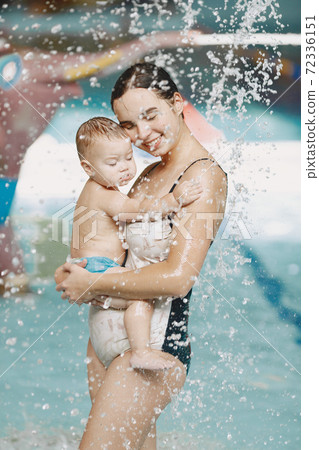 Mother and little son enjoying swimming in a swimming pool 72336151