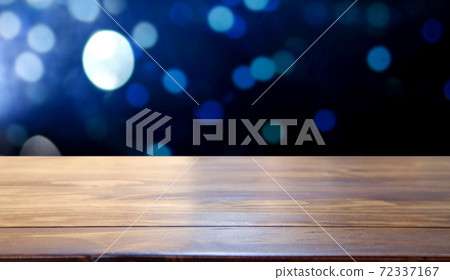 empty wooden desk space and Christmas lights in the background empty wooden desk space and Christmas lights in the background 72337167