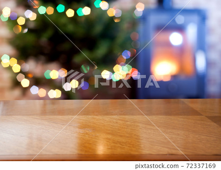 empty wooden desk space and Christmas lights in the background 72337169
