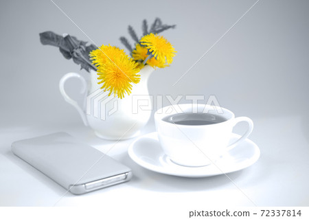 Morning tea with bouquet of yellow spring dandelion flowers. Yellow and gray. 72337814