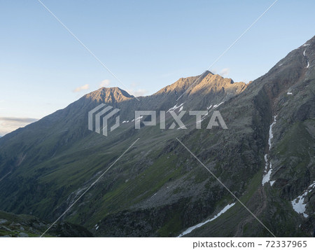 view from Nurnberger Hutte mountain hut at valley with sharp mountain peaks at Stubai hiking trail, Stubai Hohenweg, Summer rocky alpine landscape of Tyrol, Stubai Alps, Austria 72337965