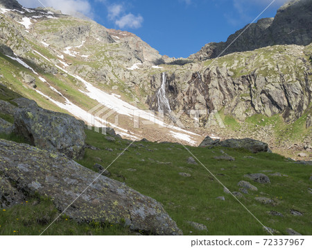 view of wild river, waterfall from melting ice at hiking trail, Stubai Hohenweg Tyrol, Austrian Alps 72337967