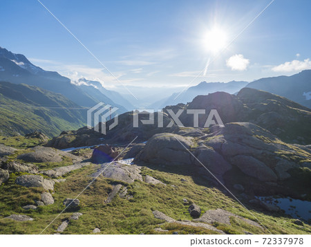 Summer morning view of Stubai valley from Bremer Hutte at hiking trail, Stubai Hohenweg, rock, boulders and moutain peaks. Tyrol Alps, Austria 72337978