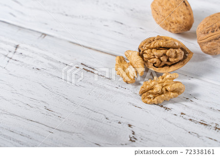 Walnuts kernels on white wooden desk, stock photo Walnuts kernels on white wooden desk, stock photo 72338161