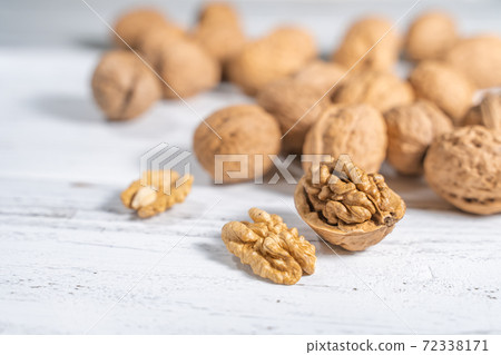 Walnuts kernels on white wooden desk, stock photo Walnuts kernels on white wooden desk, stock photo 72338171