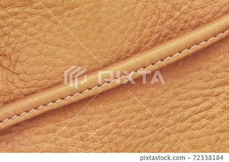 Detail of handbag with stitching, vintage genuine leather of yellow brown color. Texture and background 72338184