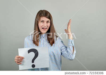 Black question mark on a piece of white paper. Close-up hand holding symbol Black question mark on a piece of white paper. Close-up hand holding symbol 72338306