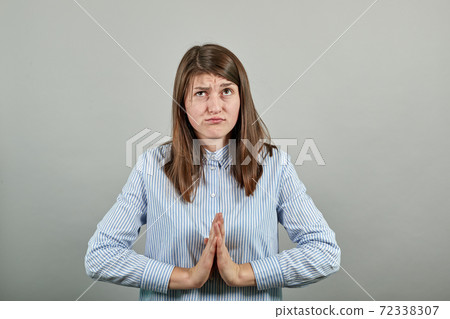Folded hands together praying asking God help ask implore wish upwards Jesus Folded hands together praying asking God help ask implore wish upwards Jesus 72338307
