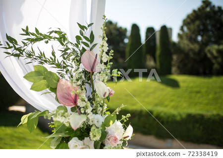 Beautiful outgoing wedding set up. Jewish Hupa on romantic wedding ceremony , wedding outdoor on the lawn. Wedding decor. A pink box for presents in the shape of a heart is on the table 72338419