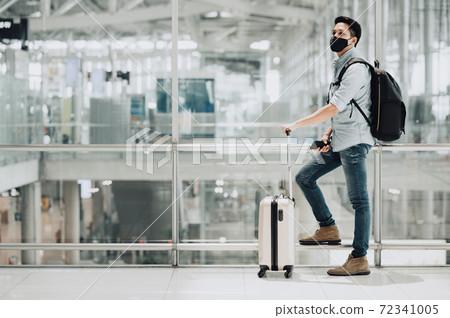 Asian man traveler wearing mask Asian man traveler wearing mask 72341005