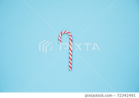 Christmas red candy cane on blue background. Merry Christmas sweets and Minimal Happy New Year concept Christmas red candy cane on blue background. Merry Christmas sweets and Minimal Happy New Year concept 72342491