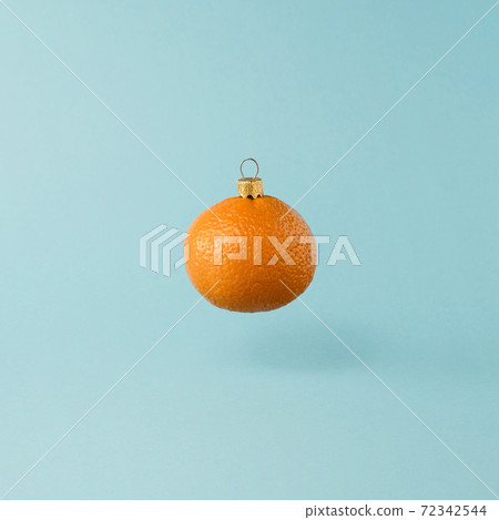 Christmas toy made from orange tangerine fruit. Minimal New Years concept. Levitation. 72342544