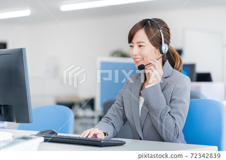 Young female operator working in the office Young female operator working in the office 72342839
