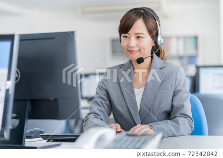 Young female operator working in the office 72342842