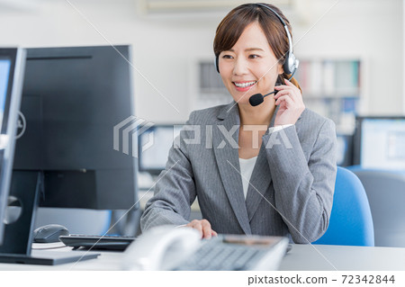 Young female operator working in the office Young female operator working in the office 72342844