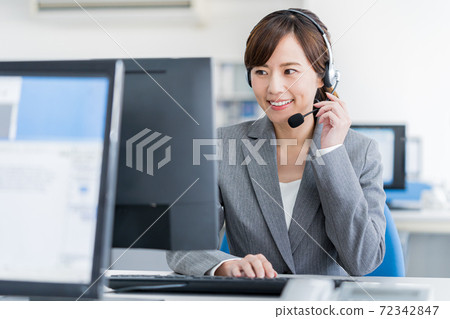 Young female operator working in the office Young female operator working in the office 72342847