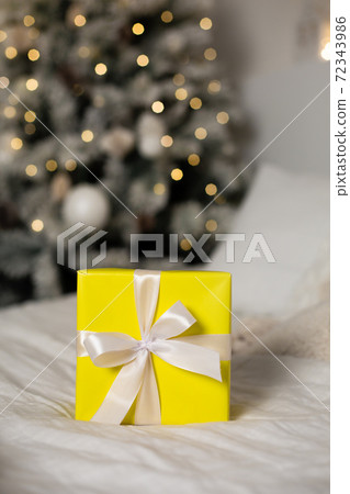 . Yellow gift with white ribbon . Yellow gift with white ribbon 72343986