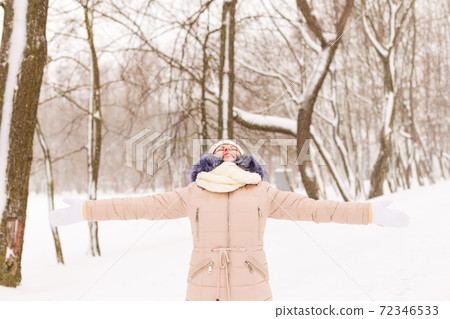 Young girl in a snowy forest in winter. Young girl in a snowy forest in winter. 72346533