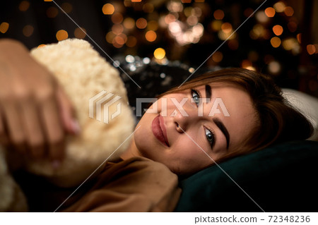 happy young woman is holding teddy bear 72348236