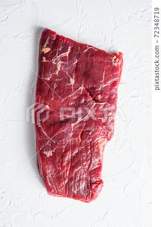 Raw skirt or flank steak,on a white stone Raw skirt or flank steak,on a white stone 72348719