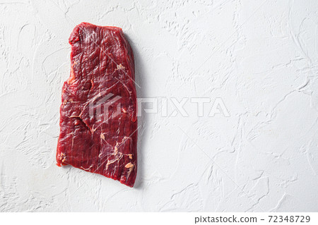 Raw skirt or flank steak,on a white stone 72348729
