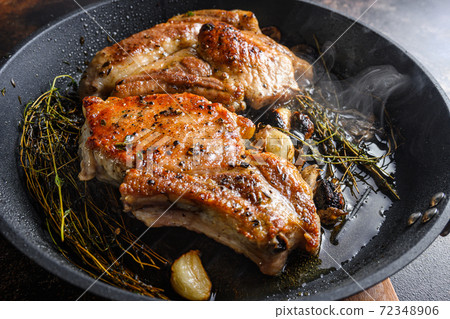 Grilled organic pork cutlets with herbs on bone in Grilled organic pork cutlets with herbs on bone in 72348906