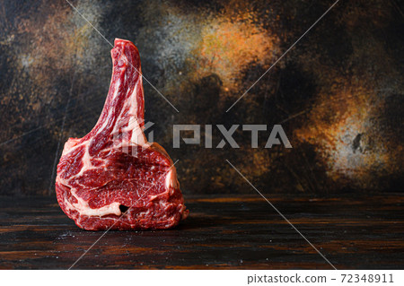 Raw Cowboy beef marbled steak in butchery side 72348911
