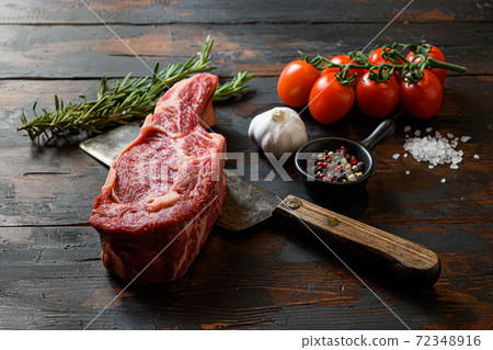 Raw Spencer steak on meat cleaver. Organic farm 72348916
