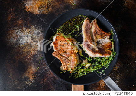 Grilled organic pork steak with herbs on bone in Grilled organic pork steak with herbs on bone in 72348949