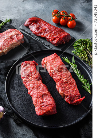 Raw denver, top blade, tri tip steak on a black Raw denver, top blade, tri tip steak on a black 72349043