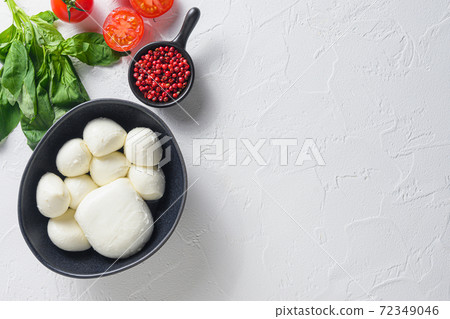 Mozzarella cheese balls with fresh basil leaves Mozzarella cheese balls with fresh basil leaves 72349046