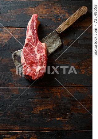 Raw Scotch Fillet steak on meat cleaver. Organic 72349058