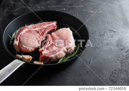 pork rib chops in frying pan grill skillet with 72349059