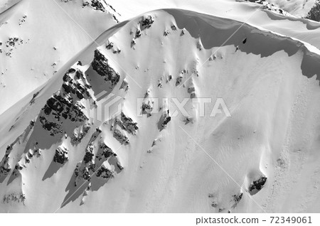 Snow cornice in winter mountains in cold sunny day 72349061