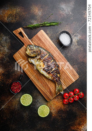 Grilled sea bream or dorado raw fish on chopping Grilled sea bream or dorado raw fish on chopping 72349704