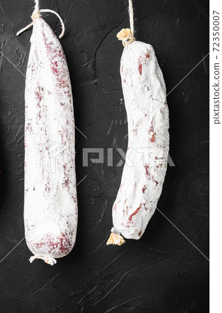 Spanish salami, fuet and chorizo sausages hang 72350007