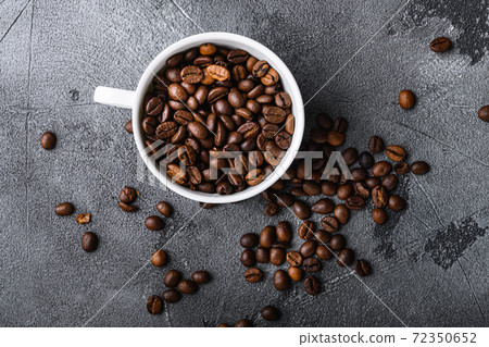 Roasted coffee beans in cup on grey textured 72350652