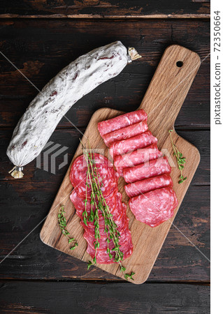 Salchichon dry cured sausages cut in slices on old 72350664