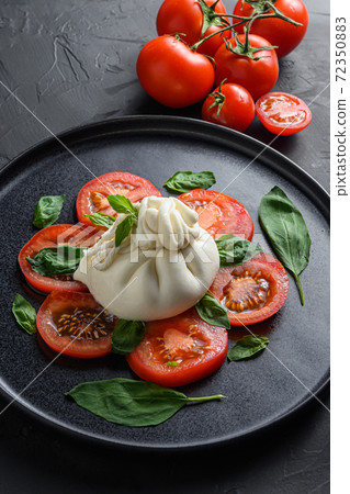 Burrata, Italian fresh cheese made from cream and 72350883