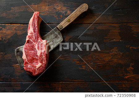 Raw Entrecote on meat cleaver. Organic farm 72350908