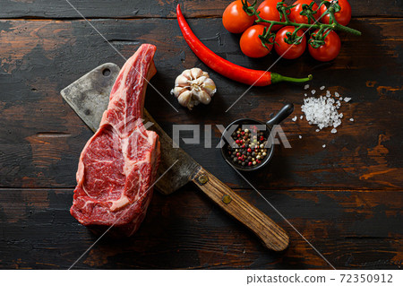 Raw Ribeye steak on meat cleaver. Organic farm 72350912