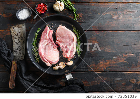 Raw pork pork rib roast in frying pan on a rustic 72351039
