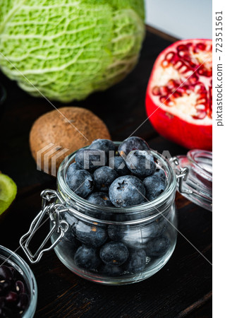 Blueberry in glass jar on dark wooden background Blueberry in glass jar on dark wooden background 72351561