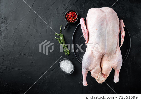 Raw whole farm duck on black background, top view, with copy space Raw whole farm duck on black background, top view, with copy space 72351599