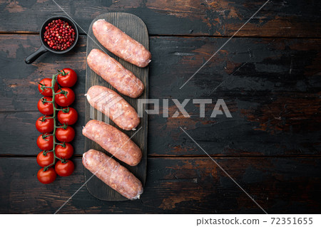 Raw pork sausages, top view with space for text, on old dark wooden background Raw pork sausages, top view with space for text, on old dark wooden background 72351655