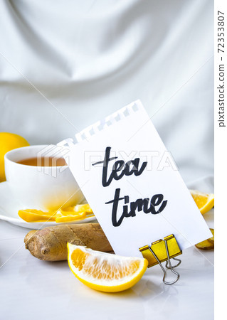 TEA TIME- written on piece of paper among the products for the treatment of common cold - lemon, ginger, chamomile tea. Vitamin natural drink TEA TIME- written on piece of paper among the products for the treatment of common cold - lemon, ginger, chamomile tea. Vitamin natural drink 72353807