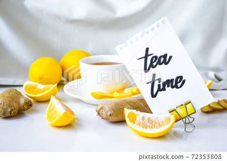 TEA TIME- written on piece of paper among the products for the treatment of common cold - lemon, ginger, chamomile tea. Vitamin natural drink 72353808