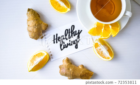 HEALTHY LIVING - written on piece of paper among the products for the treatment of common cold - lemon, ginger, chamomile tea. Vitamin natural drink 72353811
